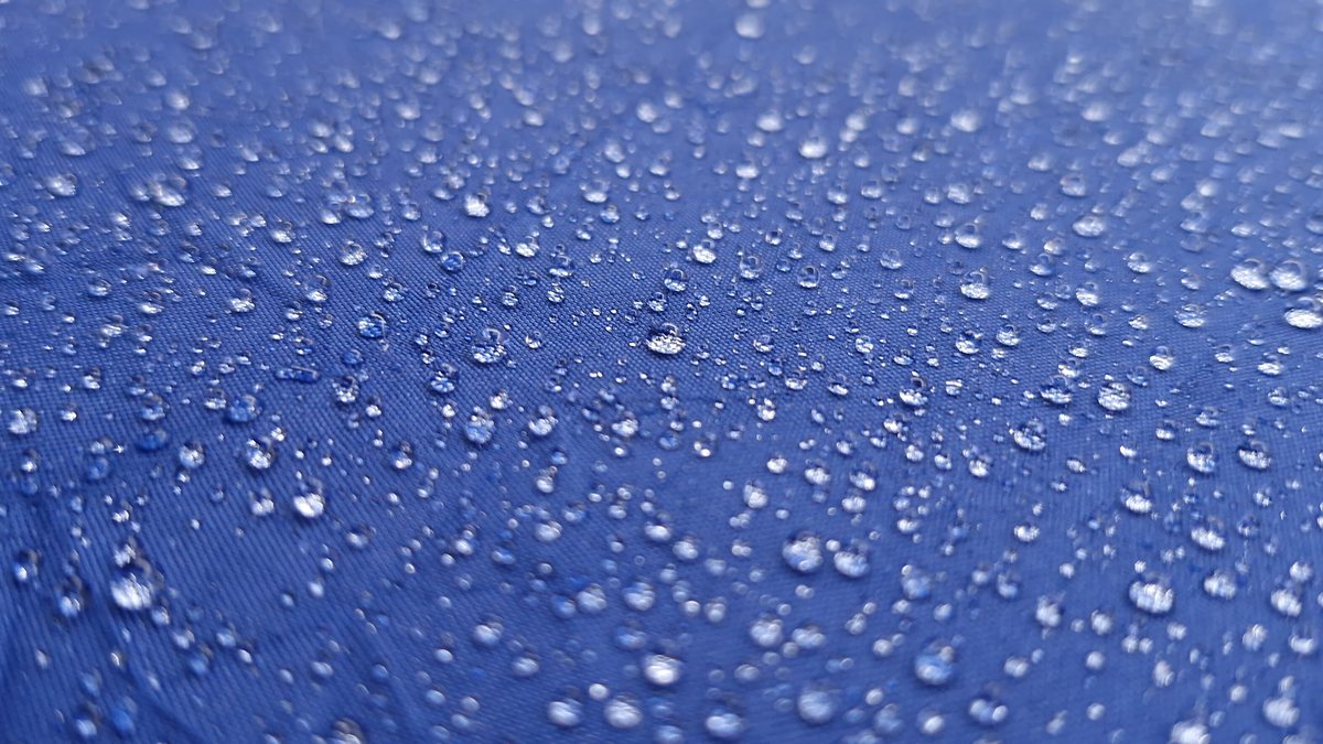 Raindrops on the surface of a blue umbrella
